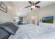 Spacious bedroom featuring vaulted ceiling, white furniture, and a mounted TV at 1631 Woodbay Ct, Kissimmee, FL 34744