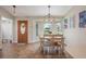 Charming dining area with bay window seating and a decorative light fixture above the dining table at 1631 Woodbay Ct, Kissimmee, FL 34744