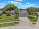 Charming home featuring a well-manicured front yard and inviting curb appeal on a sunny day at 1631 Woodbay Ct, Kissimmee, FL 34744