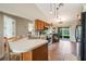 The kitchen offers light wood cabinets and stainless steel appliances with backyard access and patio view at 1631 Woodbay Ct, Kissimmee, FL 34744