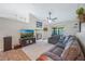 Spacious living area with vaulted ceilings, a cozy fireplace, and neutral carpet flooring at 1631 Woodbay Ct, Kissimmee, FL 34744