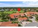 Beautiful aerial view of a home with a red tile roof on a golf course and mature landscaping at 1760 Saint Tropez Ct, Kissimmee, FL 34744