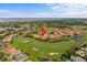Real estate aerial view of golf course homes with water views and beautiful green spaces at 1760 Saint Tropez Ct, Kissimmee, FL 34744