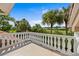 Balcony offering panoramic views of lush greenery and palm trees, creating a serene outdoor space at 1760 Saint Tropez Ct, Kissimmee, FL 34744