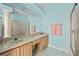 Bathroom with dual sinks, large mirror, and a walk-in shower at 1760 Saint Tropez Ct, Kissimmee, FL 34744