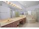 Bathroom features double sinks, lots of counter space, a large mirror, and shower at 1760 Saint Tropez Ct, Kissimmee, FL 34744