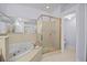 Bathroom featuring a large soaking tub and separate shower with glass door at 1760 Saint Tropez Ct, Kissimmee, FL 34744