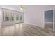 Bedroom showcasing light floors, pink walls, a ceiling fan, and outdoor access through double glass doors at 1760 Saint Tropez Ct, Kissimmee, FL 34744