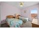 Charming bedroom featuring two twin beds and a window, perfect for guests or children at 1760 Saint Tropez Ct, Kissimmee, FL 34744