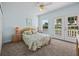 Bedroom features carpeted floors, light-colored walls, and double doors to a balcony at 1760 Saint Tropez Ct, Kissimmee, FL 34744