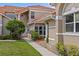 Charming two-story home with a well-maintained lawn, tile roof, and inviting walkway to the front door at 1760 Saint Tropez Ct, Kissimmee, FL 34744
