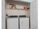 Convenient laundry room complete with a washer, a dryer, and a storage shelf at 1760 Saint Tropez Ct, Kissimmee, FL 34744
