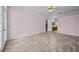 Large living room with laminated wood floors, light-colored walls, and ceiling fan at 1760 Saint Tropez Ct, Kissimmee, FL 34744