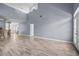Spacious living room featuring high ceilings, light wood-look floors, and natural light streaming through the doorway at 1760 Saint Tropez Ct, Kissimmee, FL 34744