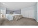 Neutral-toned loft with comfortable sofa, carpeted floors, and bright light at 1760 Saint Tropez Ct, Kissimmee, FL 34744