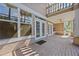 Covered patio with brick flooring and access to the main house, perfect for outdoor relaxation and entertainment at 1760 Saint Tropez Ct, Kissimmee, FL 34744