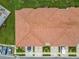 Striking aerial view of the townhouse complex featuring unique architecture, landscaping, and dedicated parking at 1870 Brentwood Ct, Davenport, FL 33837