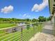 Balcony view overlooking green space, pond, and blue skies at 1870 Brentwood Ct, Davenport, FL 33837