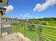 Relaxing balcony view overlooking the lush green lawn and tropical landscaping on a bright sunny day at 1870 Brentwood Ct, Davenport, FL 33837