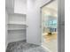 A spacious walk-in closet connects to an elegant bathroom featuring a double sink vanity and soaking tub at 1870 Brentwood Ct, Davenport, FL 33837