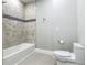 Modern bathroom featuring a toilet and a walk-in shower with designer tile at 1870 Brentwood Ct, Davenport, FL 33837