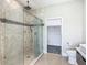 Modern bathroom featuring a glass shower with upscale tile and finishes, plus a toilet and closet area at 1870 Brentwood Ct, Davenport, FL 33837