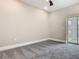 Bedroom with plush carpet, ceiling fan and a sliding glass door to a balcony at 1870 Brentwood Ct, Davenport, FL 33837