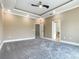 Large carpeted primary bedroom featuring an en suite bathroom and cased openings at 1870 Brentwood Ct, Davenport, FL 33837