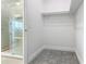 Walk-in closet connected to a bathroom featuring a frameless glass shower at 1870 Brentwood Ct, Davenport, FL 33837