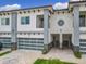 Modern townhouse with a two-car garage, balcony, and manicured landscaping at 1870 Brentwood Ct, Davenport, FL 33837