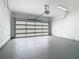 Spacious garage with modern door and painted concrete floors at 1870 Brentwood Ct, Davenport, FL 33837