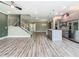 Open concept floor plan showing off the kitchen with stainless steel appliances and an island at 1870 Brentwood Ct, Davenport, FL 33837
