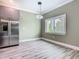 Eat in kitchen area with stainless steel refrigerator and a view to the outside at 1870 Brentwood Ct, Davenport, FL 33837