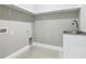 Clean laundry room with overhead shelves, a utility sink, and tile flooring at 1870 Brentwood Ct, Davenport, FL 33837