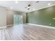 Open living room with sliding glass doors, ceiling fan, and wood-look flooring at 1870 Brentwood Ct, Davenport, FL 33837