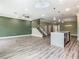Spacious living room and kitchen with stainless steel appliances and an island at 1870 Brentwood Ct, Davenport, FL 33837