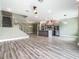 Open floor plan featuring a staircase, stainless steel appliances, and modern lighting at 1870 Brentwood Ct, Davenport, FL 33837
