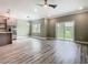 Open floor plan with stainless steel appliances, wood-look flooring, and sliding glass door at 1870 Brentwood Ct, Davenport, FL 33837
