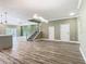 Open floor plan with stairs, modern lighting, and view of the kitchen and living areas at 1870 Brentwood Ct, Davenport, FL 33837