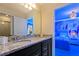 Bathroom features a granite countertop with double sinks and a door that leads into a princess themed bedroom at 2176 Lelani Cir, Davenport, FL 33897