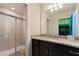 Bathroom showcases granite counters, a dark wood vanity, and a glass-enclosed shower at 2176 Lelani Cir, Davenport, FL 33897