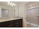 Bathroom features granite countertops with double sinks and a glass-enclosed shower at 2176 Lelani Cir, Davenport, FL 33897