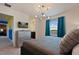 Comfortable bedroom featuring stylish decor, modern lighting, and an ensuite bathroom at 2176 Lelani Cir, Davenport, FL 33897