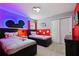 Charming bedroom featuring two twin beds, Mickey Mouse decor, and a bright, playful color scheme at 2176 Lelani Cir, Davenport, FL 33897