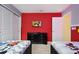 Bright ' bedroom with twin beds, a red accent wall, and a fun Mickey Mouse theme at 2176 Lelani Cir, Davenport, FL 33897