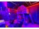 Star Wars-themed bedroom featuring a unique loft bed and gaming setup with neon lights and Star Wars decor at 2176 Lelani Cir, Davenport, FL 33897