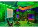 A themed bedroom with creative bunk beds, tropical accents, and unique decorative lighting at 2176 Lelani Cir, Davenport, FL 33897