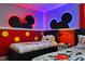 Whimsical ' bedroom with colorful Mickey Mouse themed decor and comfortable twin beds at 2176 Lelani Cir, Davenport, FL 33897
