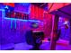 Star Wars-themed bedroom featuring a unique loft bed and gaming setup with neon lights and Star Wars decor at 2176 Lelani Cir, Davenport, FL 33897