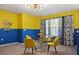 Bright dining area with unique lighting, a glass table, and playful decor in bright, cheerful colors at 2176 Lelani Cir, Davenport, FL 33897